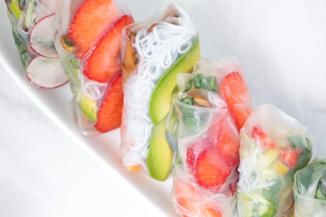 Colorful frozen smoothie packs arranged on a kitchen counter with fresh California fruits and vegetables