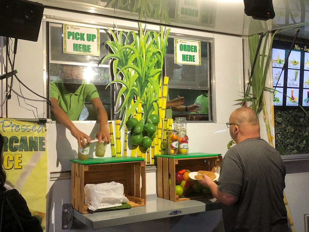 California chef preparing vegetables in a sustainable restaurant kitchen with organized scraps containers
